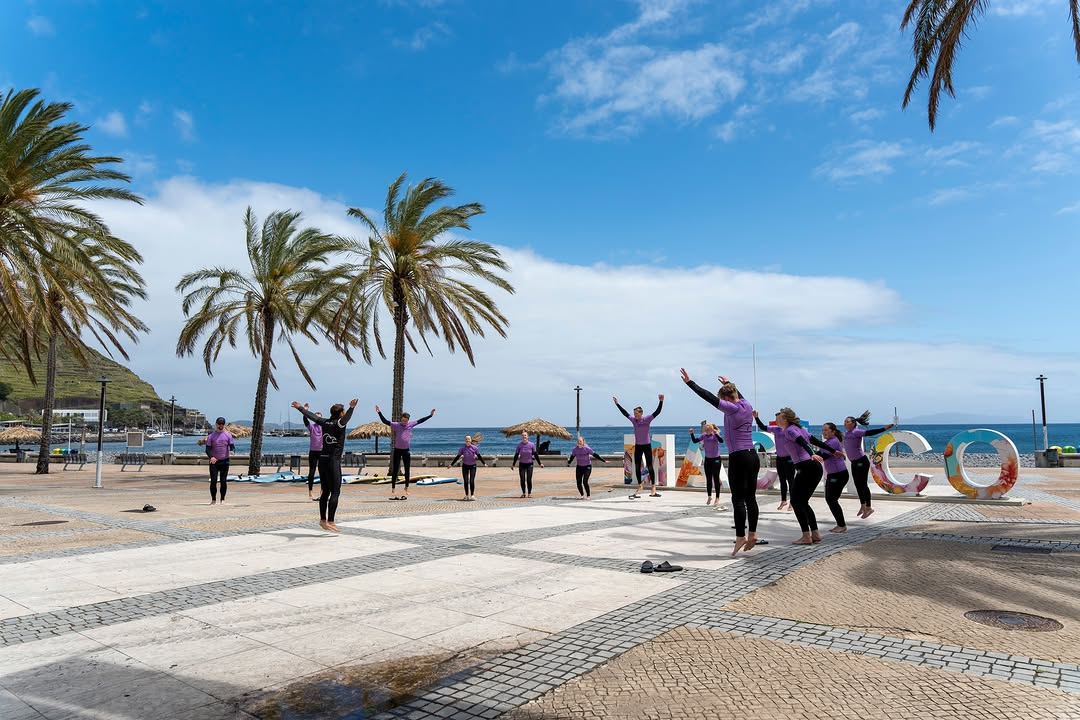 Group of surfers warming up before their surf lessons while enjoying their surf camp in madeira